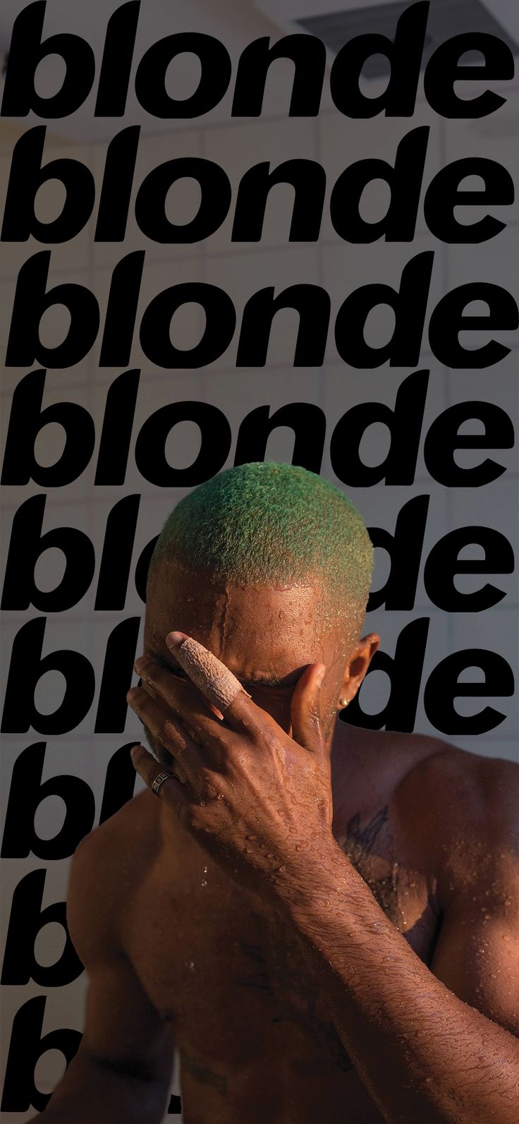 a man with green hair covering his face in front of a black and white background