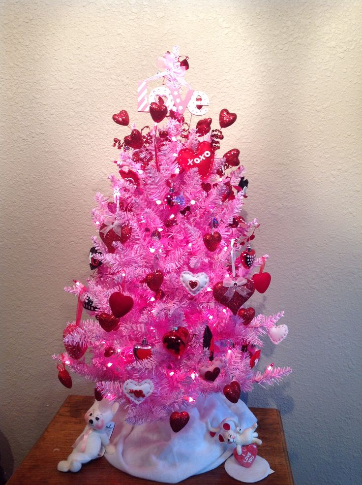 a pink christmas tree with hearts on it