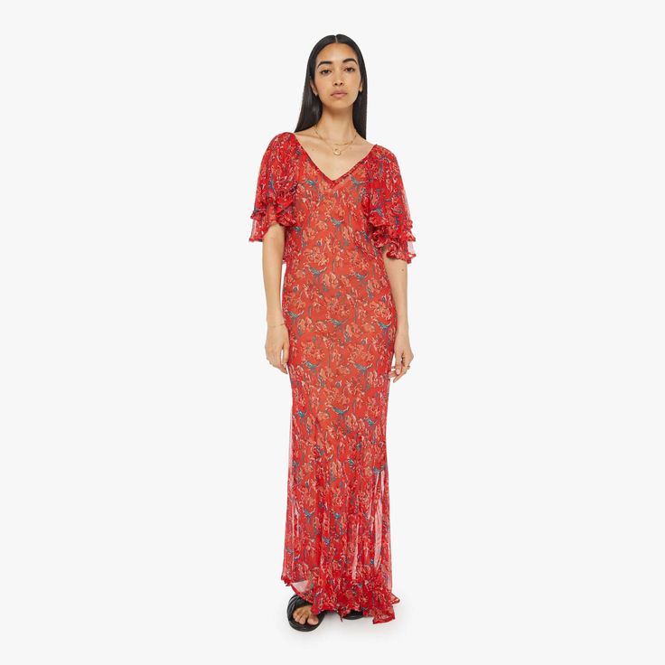 Find NATALIE MARTIN Ramya Dress on Editorialist. The Ramya dress from Natalie Martin is a maxi dress featuring a deep V-neck, elbow-length winged sleeves, and a flowy ankle-length skirt. The dress is made of a red floral print fabric and is handmade in Bali. Silk Red Floral Print Maxi Dress, Red Silk Maxi Dress For Summer, Red Floral Print Maxi Dress For Evening, Red Silk Maxi Evening Dress, Bohemian Short Sleeve Evening Dresses, Festive Bohemian Evening Dresses, Red Silk Summer Dress, Red Floral Print Evening Dress, Red Floral Print Dress For Evening