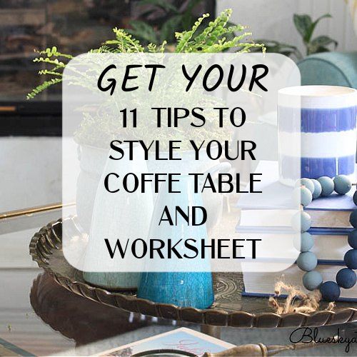 a coffee table topped with blue and white vases next to a stack of books