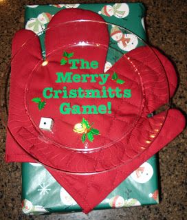 the merry cristmas plate is sitting on top of some wrapping paper and red mitts