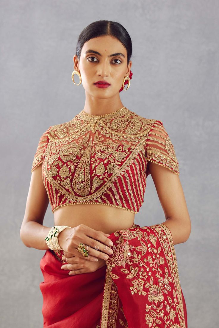 Editor's Note Featuring a bright red hand embroidered bandgala blouse with deep round back neck in butterfly net Note: Sari worn by model is for styling purposes and can be purchased separately. Color: Red Fabric: Butterfly net Components: Blouse Embroidery details: Hand embroidery + hand adda work Fit: Fitted Occasion: Engagement Care: Dry Clean Only About the Designer Torani by Karan Torani stands handcrafted luxury inspired by the myriad tales of Indian mythology. Torani is a potpourri of all Latest Bridal Lehenga Designs, Indian Mythology, Bridal Lehenga Designs, Choli Dress, Latest Bridal Lehenga, Butterfly Net, Fashionable Saree Blouse Designs, Sari Blouse Designs, Choli Designs