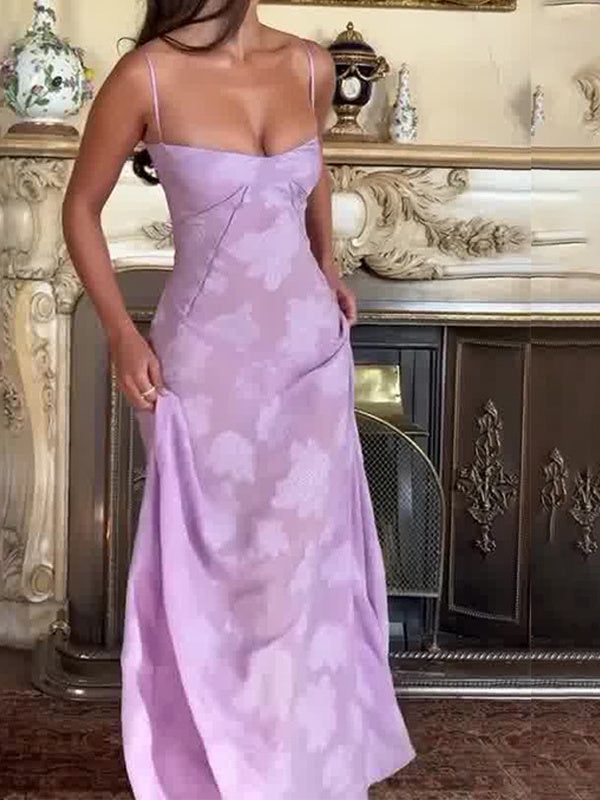 a woman in a purple dress standing next to a fireplace