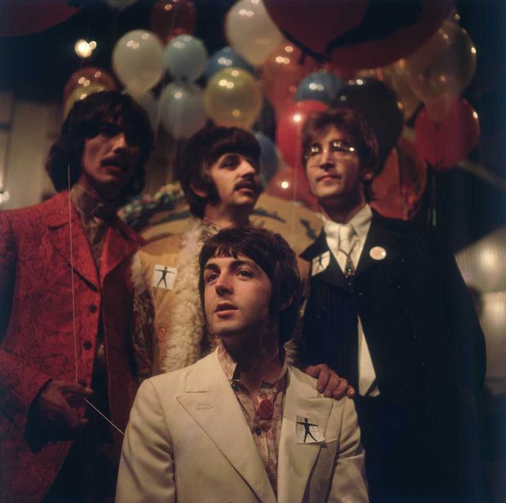 the beatles are posing for a photo in front of balloons