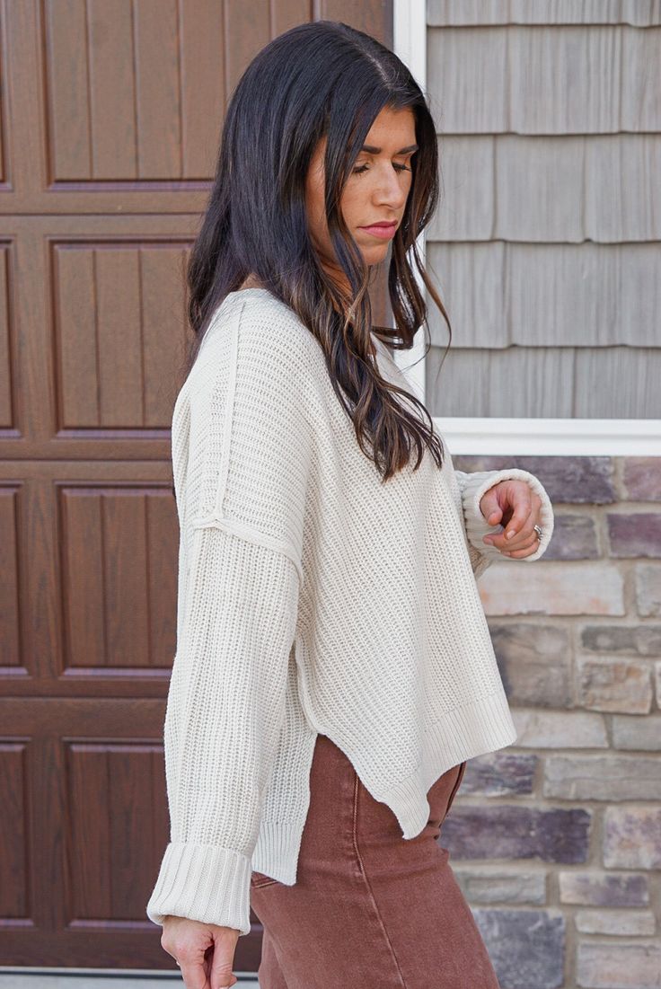 Ivory ribbed knit boxy cropped sweater Total perfection! Ivory ribbed knit boxy sweater, in a semi cropped style. Featuring a crew neckline, long sleeves with drop shoulder and reverse seam detail, and side slits in the bottom hemline. This babe is adorable, and so comfy. We love love love! Boxy fit; semi cropped Model is 5'3" wearing a small Fabric contains stretch Crew neckline Long sleeves with drop shoulder and reverse seam detail Side slits in bottom hemline Unlined, non-sheer. Midweight 10 Cropped Sweaters, Sweaters Winter, Semi Cropped, Winter Styles, Peach Love, Boxy Sweater, Vintage Couture, Winter Trends, Clothing Logo