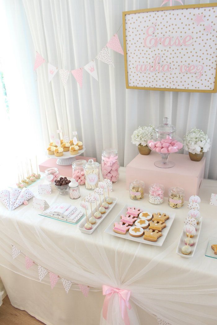 a table topped with lots of desserts and cupcakes on top of it