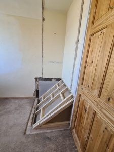 an empty room with wooden doors and stairs