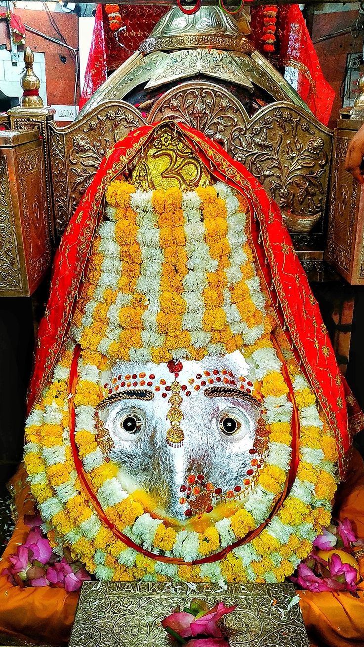 an elephant statue is decorated with flowers and garlands