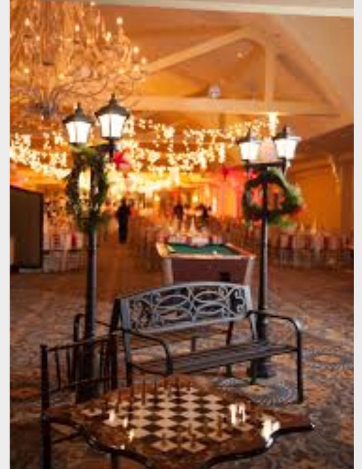 an empty banquet hall with chandeliers and tables set up for a formal function