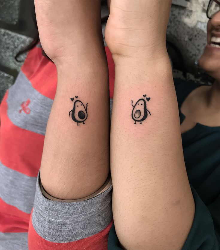 two people with matching tattoos on their arms