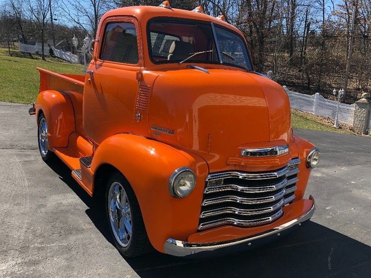 an orange truck parked in a parking lot