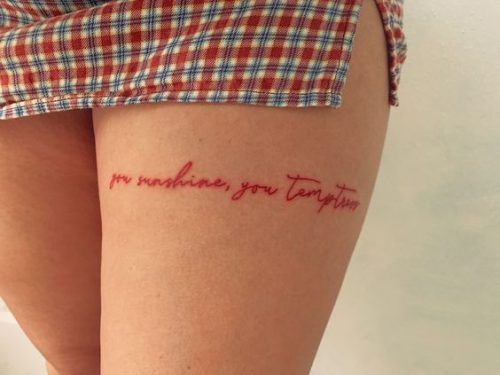 a woman's thigh with the words i love you written on it in cursive red ink