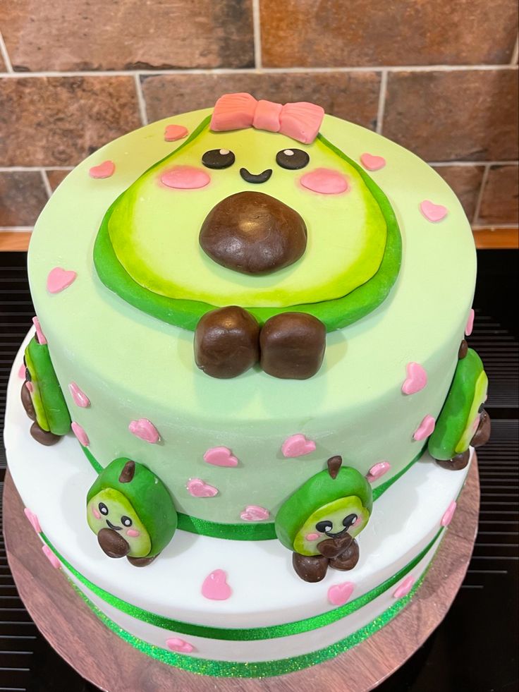 there is a cake decorated with green and pink decorations