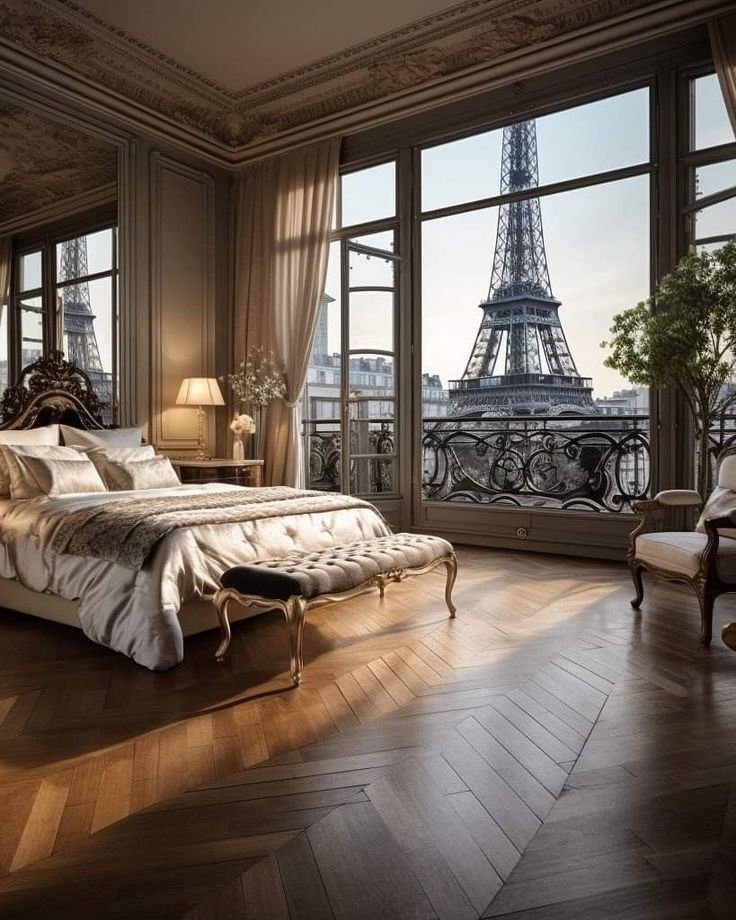 a bedroom with a view of the eiffel tower from it's windows