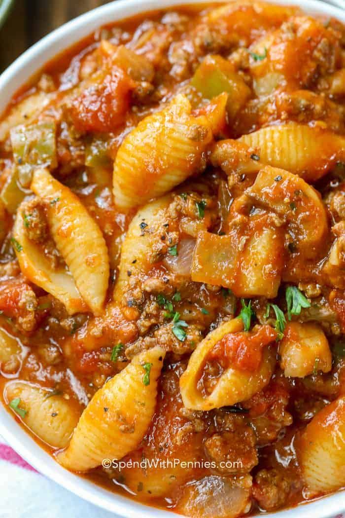 a bowl filled with pasta and meat in tomato sauce