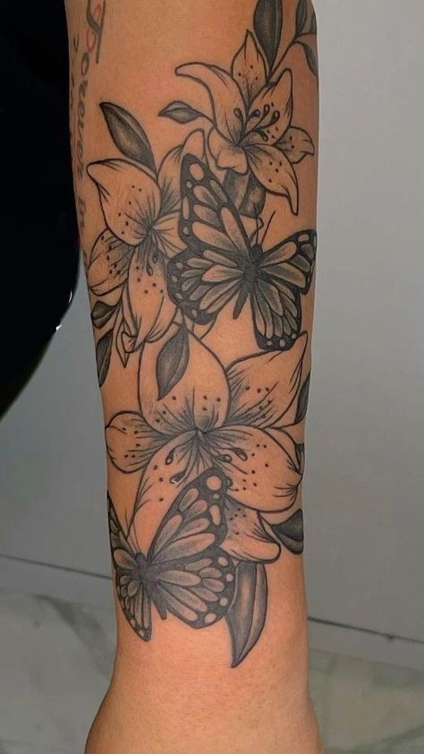 a woman's leg with flowers and butterflies tattoo on the side of her body