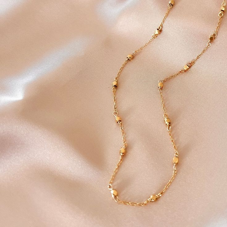 Our signature gold chain. Uniquely designed for layering over any necklace in our collection. Handmade, tarnish resistant 14k gold plated chain. Adjustable between 16"-18". Minimalist Gold Necklace With Satellite Chain, Gold Plated Delicate Chain Necklace, Gold-plated Satellite Chain Necklace, Gold Plated Delicate Chain Choker Necklace, Yellow Gold Long Charm Necklace With Delicate Chain, Delicate Gold-plated Chain Necklace, Delicate Gold-plated Choker Necklace, Minimalist Gold Plated Satellite Chain Necklace, Delicate Link Chain Necklace With Satellite Chain