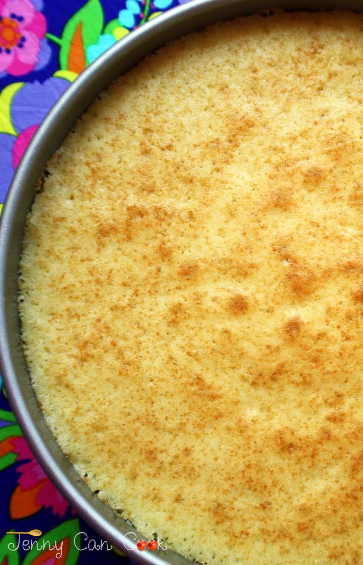 a pan filled with food sitting on top of a colorful table cloth