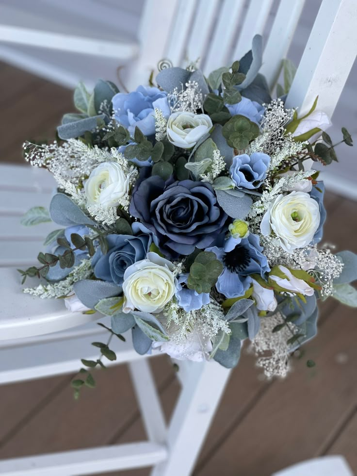 a blue and white bouquet sitting on top of a chair