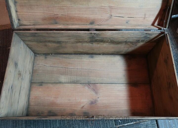 an old wooden box sitting on the ground