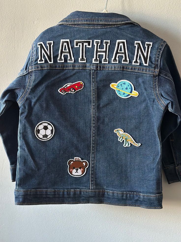 Custom toddler boys denim jacket. Sizes 12 months to 5T. * please note patches vary at random but all are adorable and kid friendly.  ** if there is a specific item you are interested in including let us know and we will try our best to accommodate your request! Playful Cotton Denim Jacket With Pockets, Blue Cotton Denim Jacket For Playtime, Playtime Denim Jacket With Pockets, Denim Outerwear For Playtime, Denim Outerwear With Pockets For Playtime, Cute Denim Outerwear With Patches, Casual Cotton Denim Jacket For Playtime, Long Sleeve Denim Jacket For Playtime, Long Sleeve Denim Jacket With Pockets For Playtime