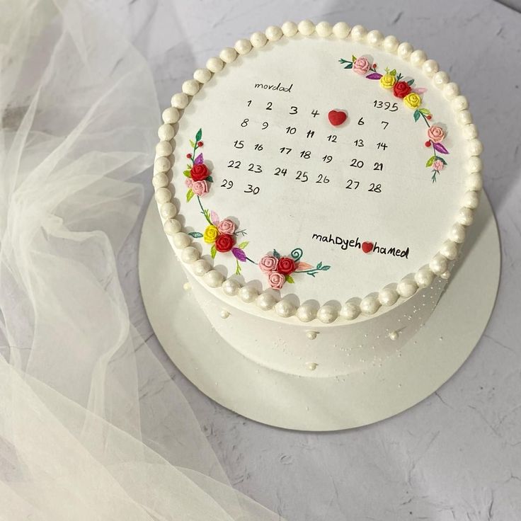 a white cake with flowers on it sitting on a table