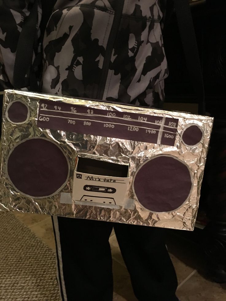 a person is holding up a boombox made out of tin foil and tape recorders