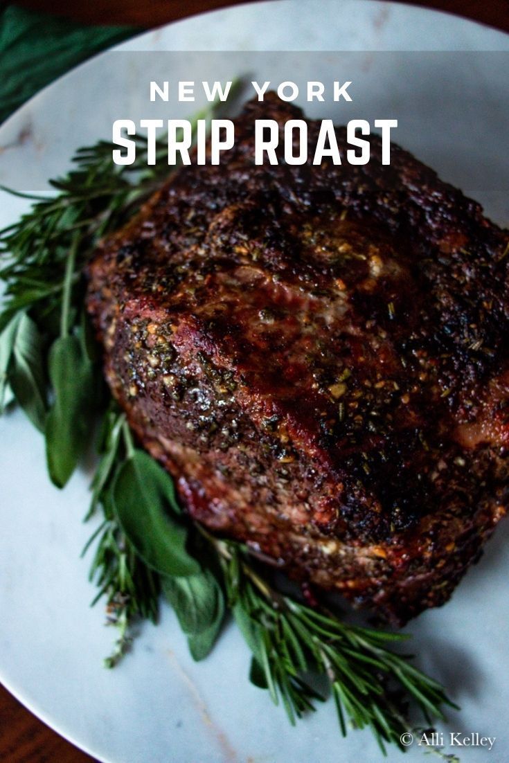 new york strip roast on a plate with herbs