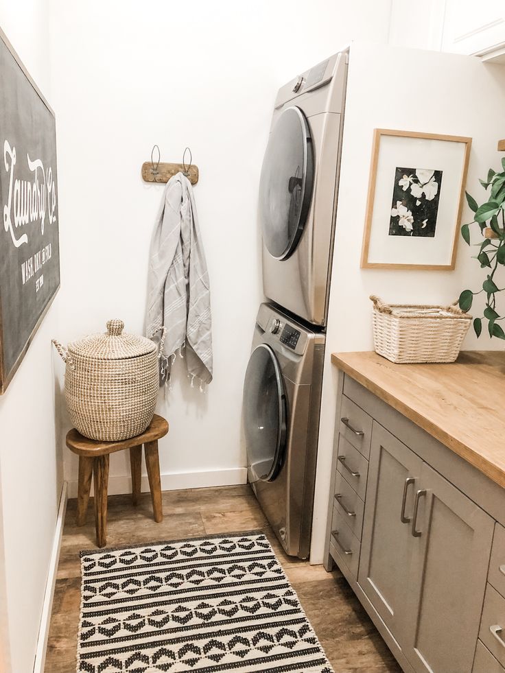 a small laundry room with washer and dryer on the wall next to it