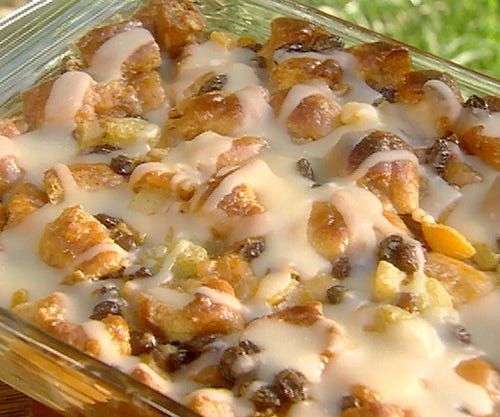 a casserole dish with raisins, nuts and cheese on it sitting in the grass