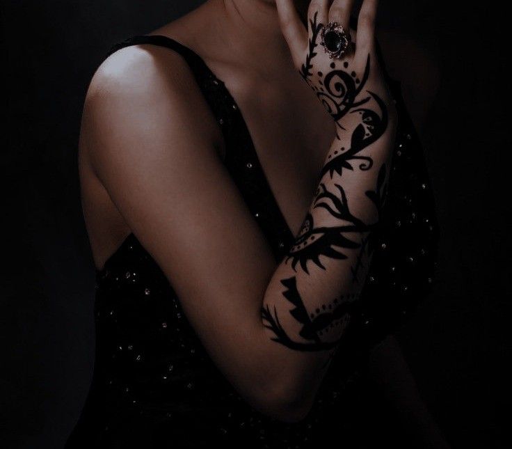 a woman with tattoos on her arms and hands