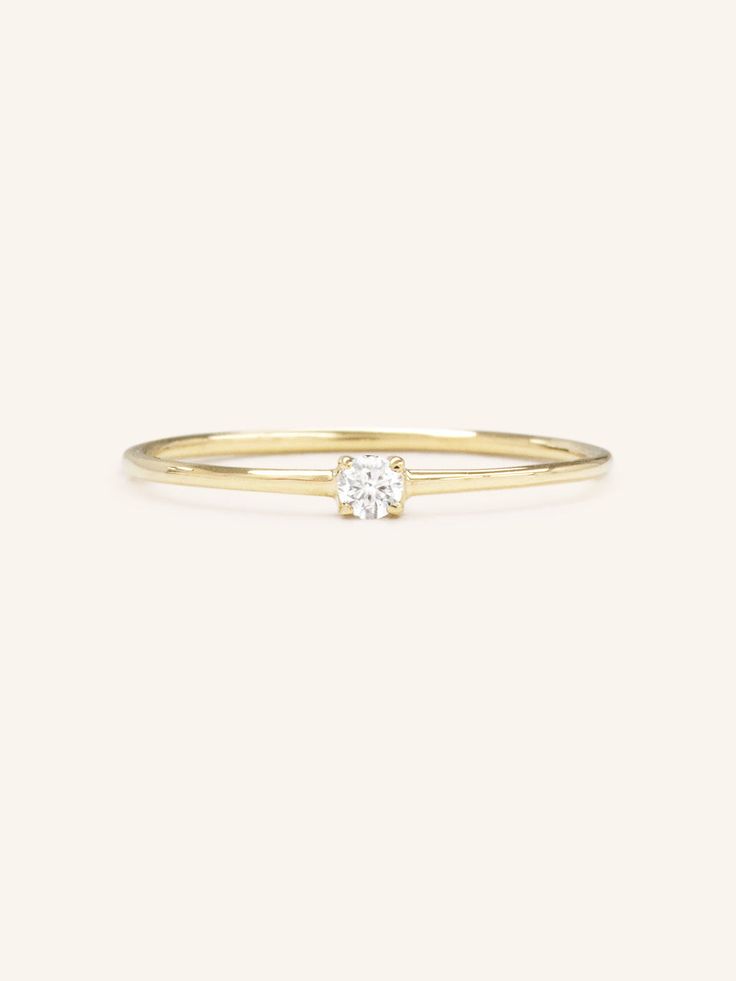 A luminous quintessential beauty. This petite four-prong ring features a sparkling diamond. It's set in a dainty ring that can be worn from day to night. Delicate Diamond Ring Vs Clarity, 14k Gold Cluster Ring With Single Diamond, Classic Diamond Midi Rings For Anniversary, Dainty Diamond Ring With Vs Clarity, Timeless Diamond Solitaire Stackable Rings, Minimalist 14k Gold Cluster Ring With Prong Setting, Timeless Solitaire Diamond Stackable Rings, Minimalist Cluster Ring With Prong Setting, Delicate Diamond Birthstone Ring With Prong Setting