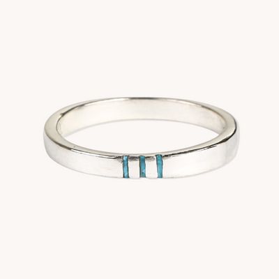 a white gold ring with two blue stripes