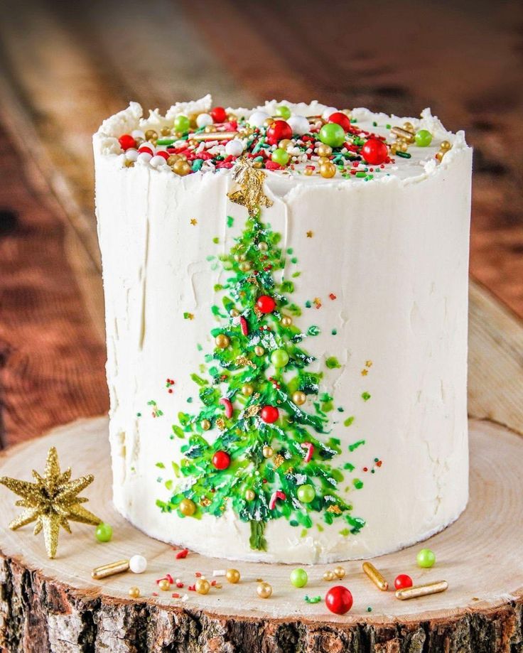 a decorated christmas cake sitting on top of a tree stump