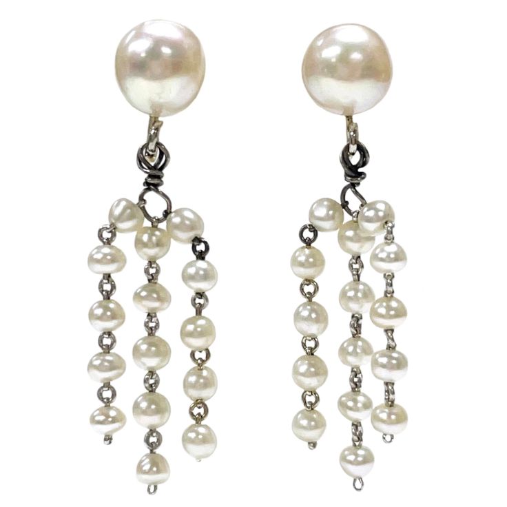 14 Karat White Gold Cultured Pearl Dangle Earrings. One pair of cultured pearl earrings. Each earring is comprised of one 8.0 to 8.5mm diameter close to spherical cultured pearl peg set onto a pad with three strands of five pearls each dangling from a jump-ring below. Each strand is joined by white gold wire loops between the approximately 3.0 to 3.1mm diameter pearl. The earrings have a post and friction backs for pierced ears. The earrings weigh 4.9 grams overall. The two larger pearls are cre Pearl Dangle Earrings, Pearl Earrings Dangle, Toned Body, Light Cream, Gold Wire, Dream Jewelry, Earrings Dangle, Cultured Pearls, Jump Rings