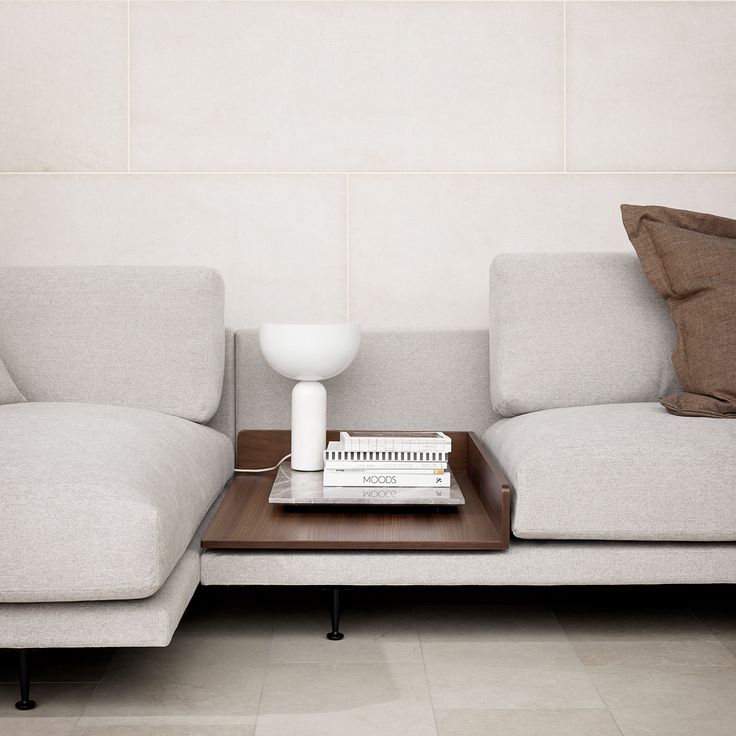 a living room with two couches, a table and a lamp on the coffee table