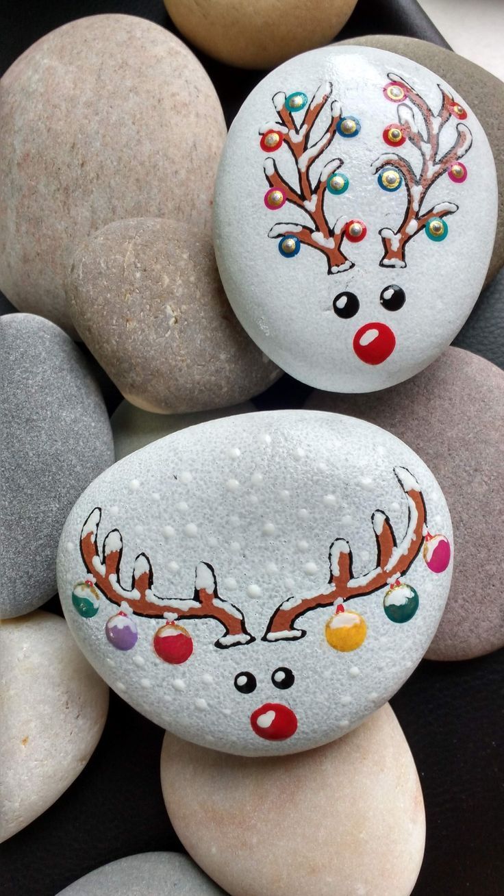 some rocks with painted reindeer faces on them