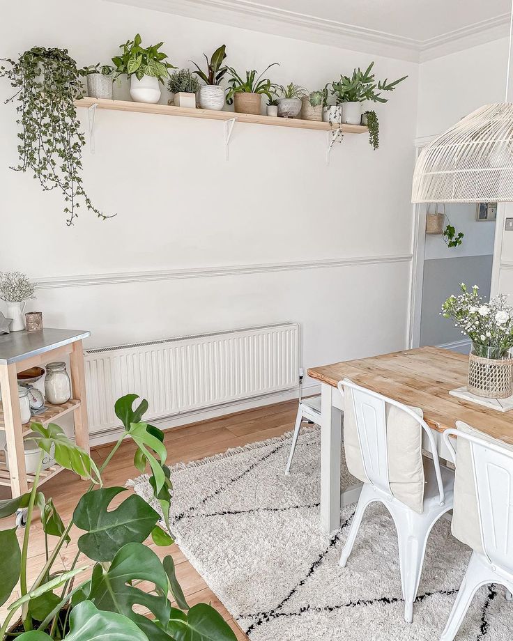 a living room with plants on the wall and a table in front of it,