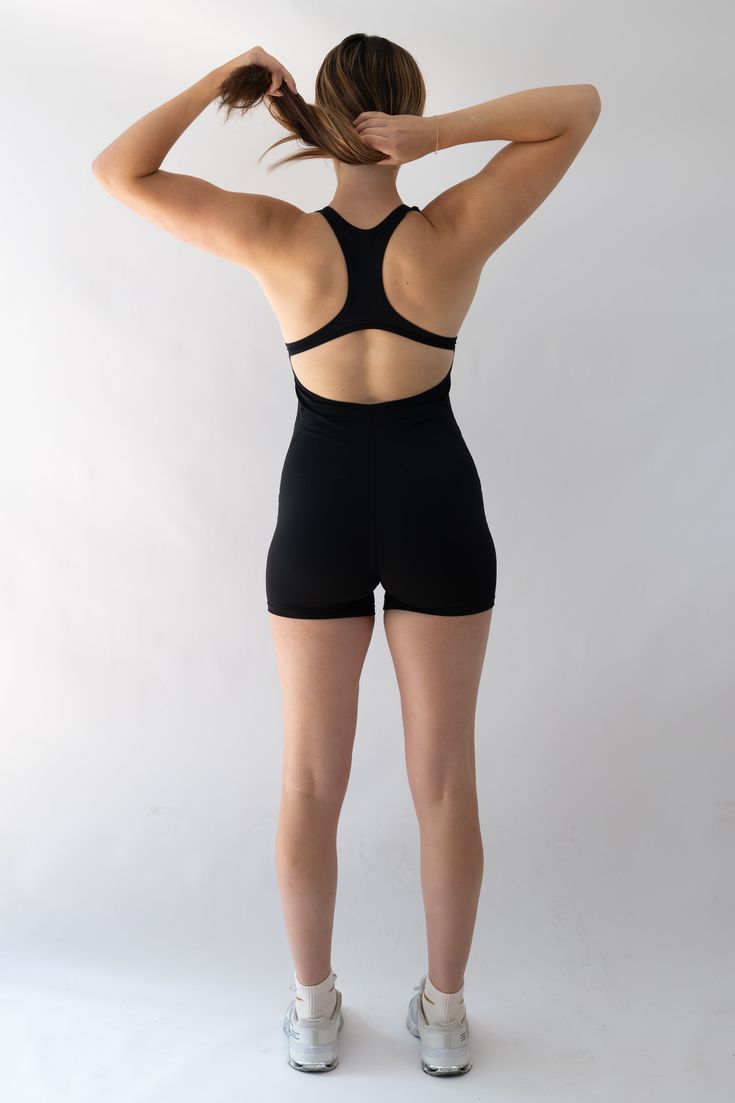 Mix Up Your Routine The Solo Playsuit is designed to take the classic sports bra and shorts combo even further. Developed to truly be the best of both worlds, you’ll find flexibility and comfort with every move. Strappy backside design highlights your back while providing full coverage in the front for a sleek silhouette. Soft touch fabric offers a 4-way stretch and quick drying features to alleviate moisture so it’ll feel like wearing a second skin. Black Unitard With Built-in Bra For Workout, Sporty Unitard With Built-in Bra For Gym, High Stretch Sports Unitard With Built-in Bra, Sleeveless Sports Unitard With Built-in Bra, Padded Back Stretch Sports Bra, Workout Activewear With Built-in Bra, Short Length, Stretch Swimwear With Built-in Padding For Training, Fitted Racerback Activewear With Built-in Padding, Compression Activewear With Built-in Bra And Short Length