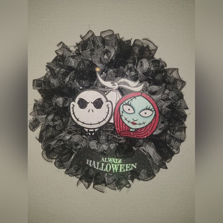 a halloween wreath with two faces on it