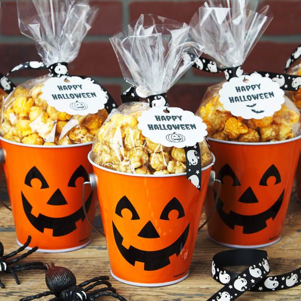 three orange buckets filled with halloween popcorn