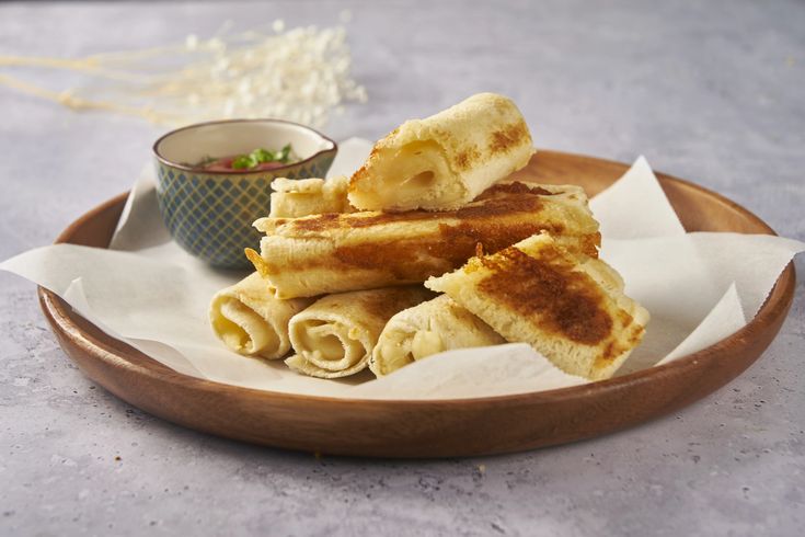 some food that is on a plate and sitting on a table next to a bowl