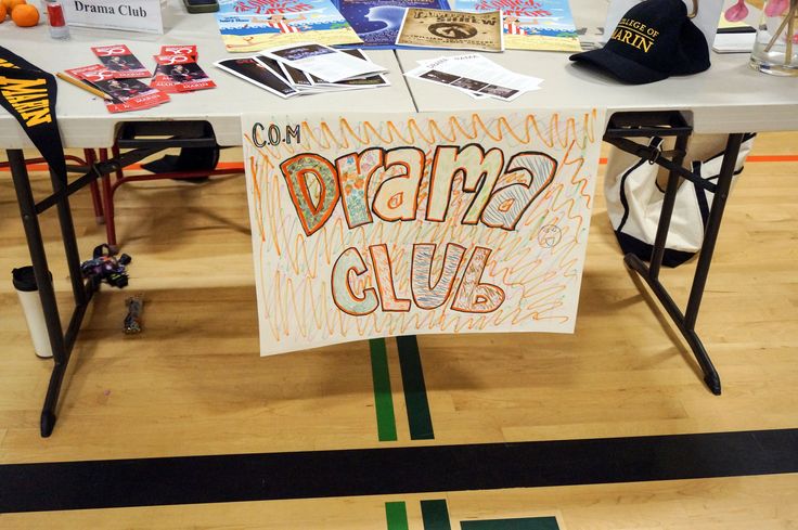 a sign that says dream club on it at a table with other signs and decorations