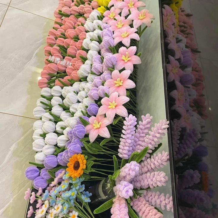 colorful flowers are arranged on display in a store