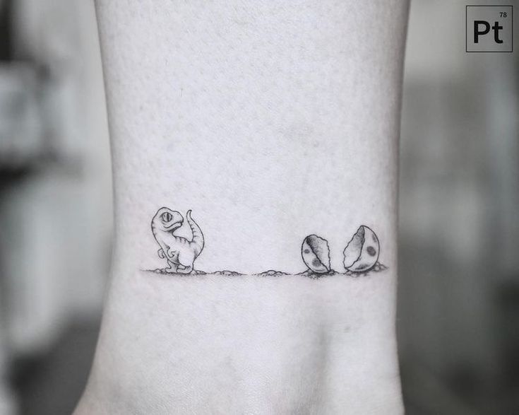 a small tattoo on the ankle of a woman's foot, depicting two birds