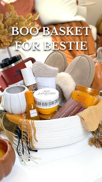 a basket filled with lots of items on top of a white table next to pumpkins