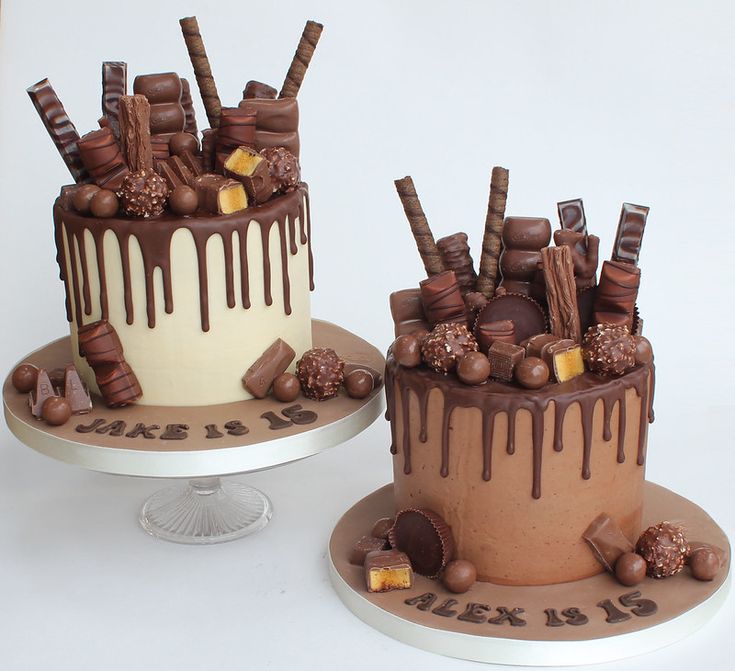 two cakes decorated with chocolate and candy bars