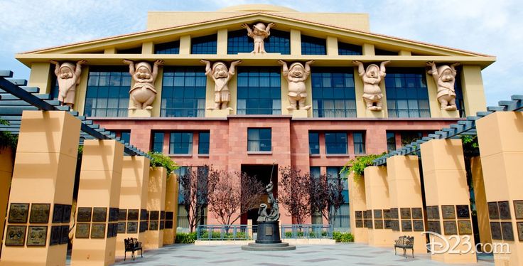 a large building with statues on the front and side of it's entrance area