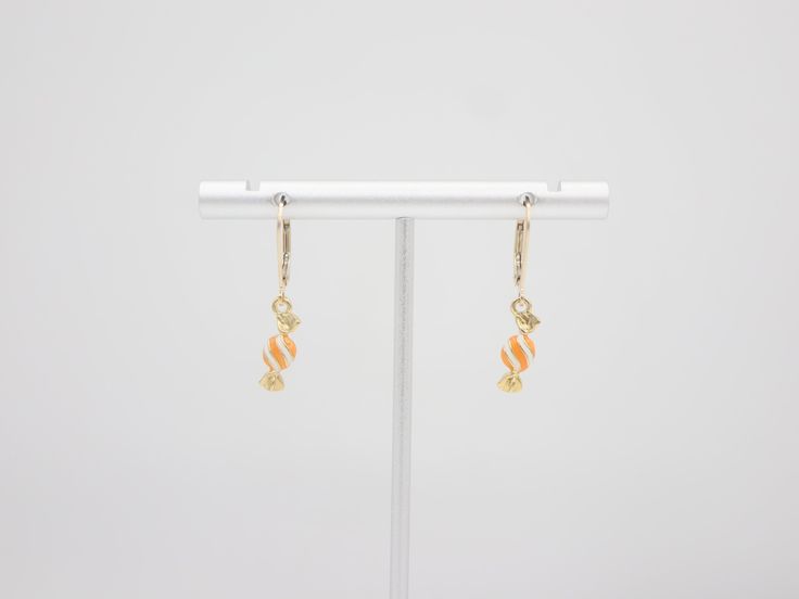 🎉Tiny enamel candy dangle earrings. 🎉Design and handcraft in our Burlington Studio ------------------------------------------------------------- PRODUCTS DETAILS Length: 29mm Width: 5mm Lever back: 14K gold filled Candy drop: 14K gold plated enamel ------------------------------------------------------------- SAME COLLECTION Necklace https://www.etsy.com/ca/listing/771460195/tiny-enamel-candy-necklace-14k-gold?click_key=b044d590c58e79aa95964c877bc70f9e68f174fc%3A771460195&click_sum=5f3b091c&ref=shop_home_active_28&sts=1 ------------------------------------------------------------- MATERIALS INTRODUCTION:  GOLD FILLED FINDINGS Gold filled is an actual layer of 5% pure gold by weight pressure bonded to another metal. Gold filled is not to be confused with gold plating as filled literally h Yellow Gold Enamel Dangle Earrings, Sweet Nickel-free Jewelry For Gifts, Sweet Nickel-free Jewelry Gift, Yellow Gold Charm Earrings For Gift, White Enamel Jewelry For Party, Sweet Nickel-free Dangle Jewelry, Sweet Drop Earrings Jewelry Gift, Handmade Gold Sweet Jewelry, Sweet White Earrings For Birthday