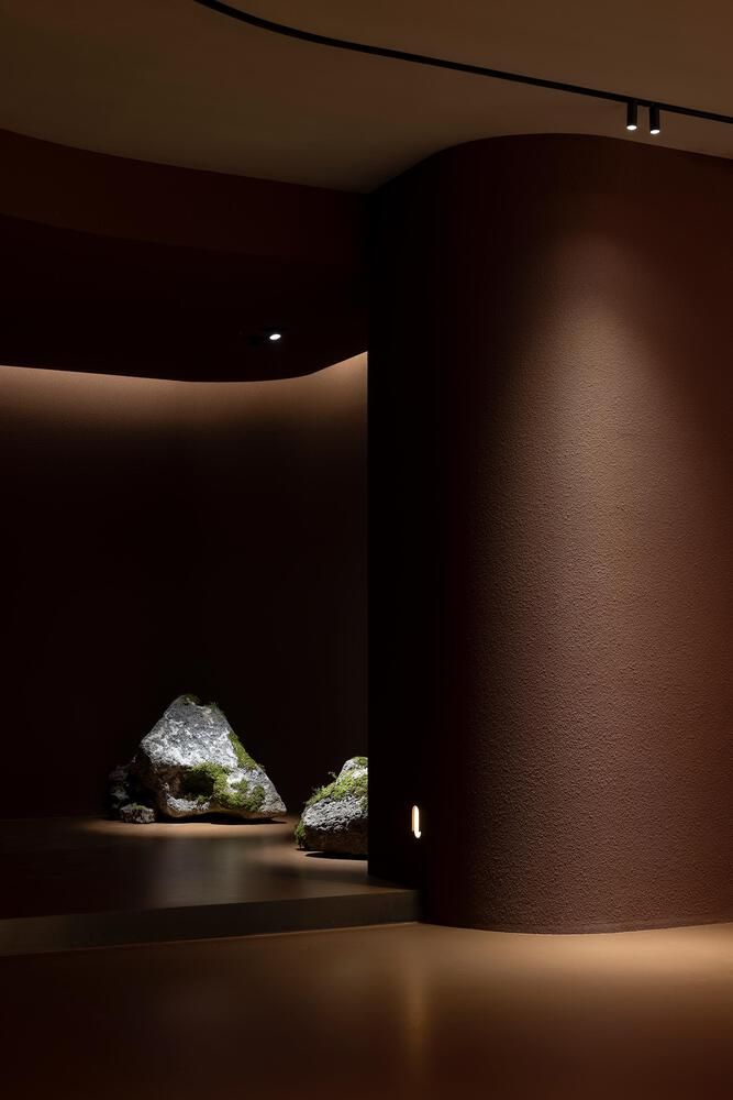 an empty room with rocks in the center